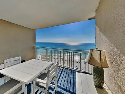 a balcony with a table and chairs and the ocean at Emerald Beach #936 in Panama City Beach