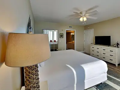 a bedroom with a bed and a ceiling fan at Emerald Beach #936 in Panama City Beach