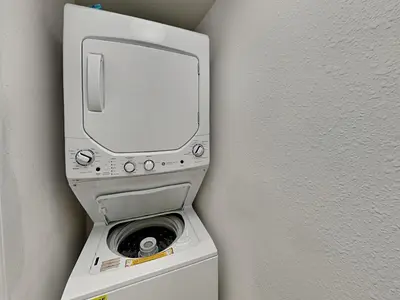 a dvd player on top of a washing machine at Emerald Beach #936 in Panama City Beach