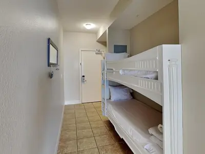 a small room with two bunk beds with towels at Tidewater Beach Resort #1306 - Beach Bliss in Panama City Beach