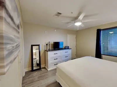 a bedroom with a bed and a ceiling fan at Tidewater Beach Resort #1306 - Beach Bliss in Panama City Beach