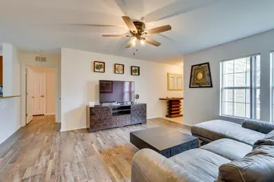 a living room with a couch and a flat screen tv at PCB Condo with Pool Access 1 Mi to Beach! in Panama City Beach