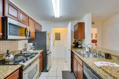a kitchen with a sink and a stove at PCB Condo with Pool Access 1 Mi to Beach! in Panama City Beach