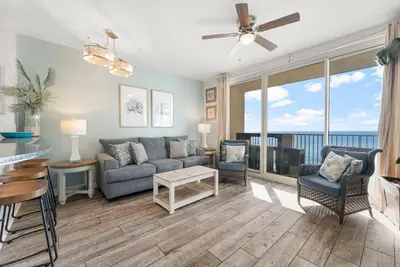a living room with a couch and a table at Shores of Panama #1420 by Nautical Properties in Panama City Beach