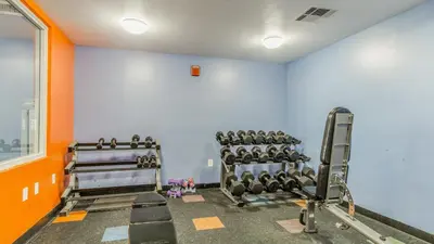 a gym with rows of tread machines in a room at Shores of Panama #1420 by Nautical Properties in Panama City Beach