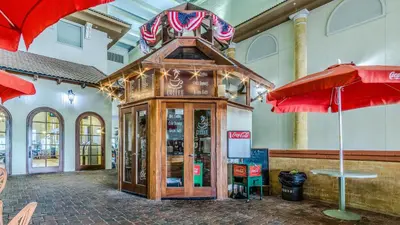 a store with red umbrellas in a building at Shores of Panama #1420 by Nautical Properties in Panama City Beach