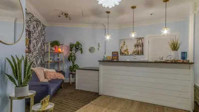 a living room with a counter and a blue couch at Shores of Panama #1420 by Nautical Properties in Panama City Beach
