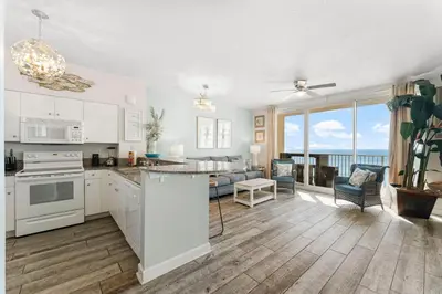 an open kitchen and living room with a view of the ocean at Shores of Panama #1420 by Nautical Properties in Panama City Beach