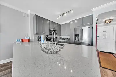 a large kitchen with a large white counter top at Twin Palms 1802 in Panama City Beach