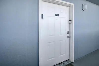 a white door in a room with a door sidx sidx at Twin Palms 1802 in Panama City Beach
