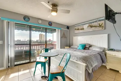 a bedroom with a bed and a table and chairs at Panama City Beach Getaway - Walk to Beaches! in Panama City Beach
