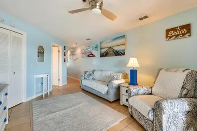 a living room with a couch and a chair at Panama City Beach Getaway - Walk to Beaches! in Panama City Beach