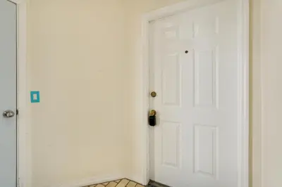 a white door in a room with a tile floor at Panama City Beach Getaway - Walk to Beaches! in Panama City Beach