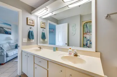 a bathroom with two sinks and a mirror at Panama City Beach Getaway - Walk to Beaches! in Panama City Beach