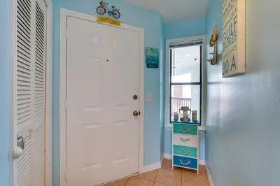 a hallway with a white door in a room at Panama City Beach Getaway - Walk to Beaches! in Panama City Beach