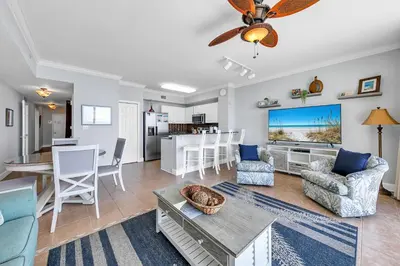 a living room with a couch and a table at Tidewater 1113 in Panama City Beach
