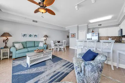 a living room with a couch and a table at Tidewater 1113 in Panama City Beach