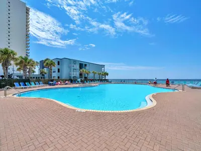 a large swimming pool next to the beach at Tidewater 1113 in Panama City Beach