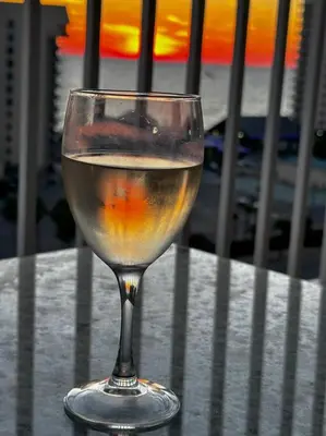 a glass of wine sitting on top of a table at Melan Villa Costal Magic Ocean View in Panama City Beach