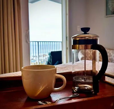 a coffee pot and a cup on a table at Melan Villa Costal Magic Ocean View in Panama City Beach
