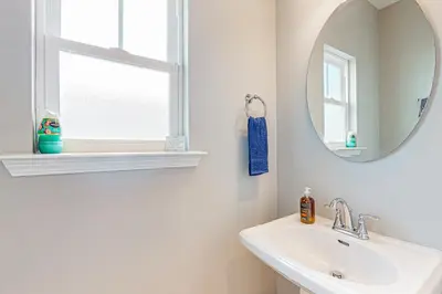 a white bathroom with a sink and a mirror at Walk to Eats! Family Hideaway 16 Mi to PCB in Callaway