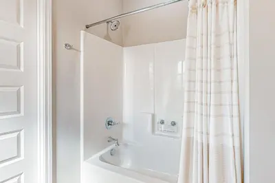 a bathroom with a shower curtain and a sink at Walk to Eats! Family Hideaway 16 Mi to PCB in Callaway