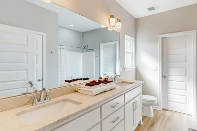 a bathroom with a sink and a toilet and a mirror at Walk to Eats! Family Hideaway 16 Mi to PCB in Callaway