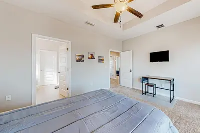 a bedroom with a bed and a ceiling fan at Walk to Eats! Family Hideaway 16 Mi to PCB in Callaway