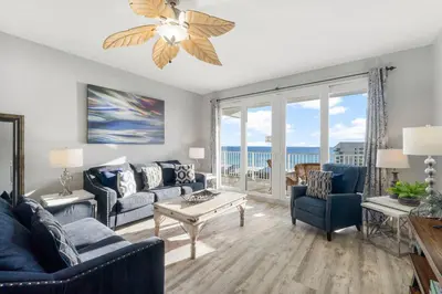a living room with a blue couch and chairs at Laketown Wharf #1007 by Nautical Properties in Panama City Beach