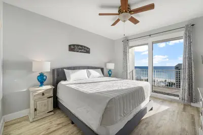 a bedroom with a bed and a large window at Laketown Wharf #1007 by Nautical Properties in Panama City Beach