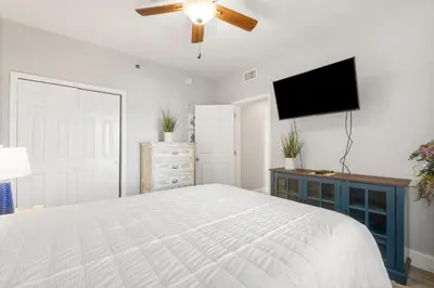 a bedroom with a bed and a flat screen tv at Laketown Wharf #1007 by Nautical Properties in Panama City Beach