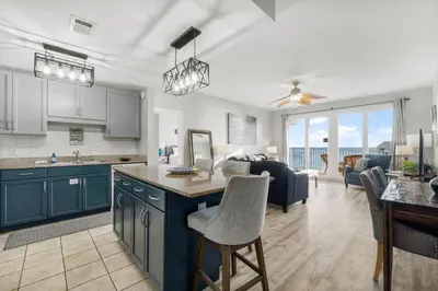 a kitchen and living room with a view of the ocean at Laketown Wharf #1007 by Nautical Properties in Panama City Beach