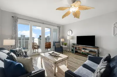 a living room with a couch and a tv at Laketown Wharf #1007 by Nautical Properties in Panama City Beach
