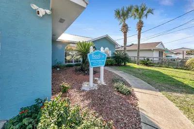 a blue stop sign in front of a house at Manatee Summer House in Panama City Beach