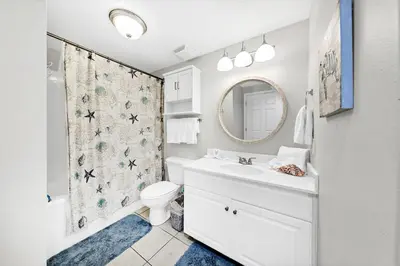 a bathroom with a sink and a toilet and a mirror at Majestic Beach Towers 1-2015 in Panama City Beach