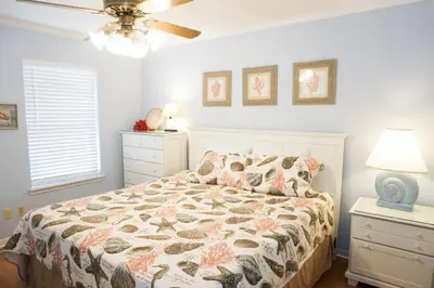 a bedroom with a bed and a ceiling fan at Venture Out 79 Gulf Loop Comes With Golf Cart in Panama City Beach