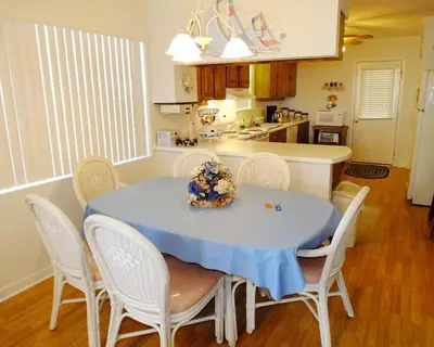 a kitchen with a table with a blue table cloth on it at Venture Out 79 Gulf Loop Comes With Golf Cart in Panama City Beach