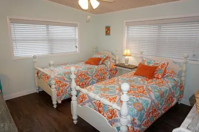 a bedroom with two beds and a window at Venture Out 41 Gulf Loop 2bd 1ba WITH GOLF CART in Panama City Beach
