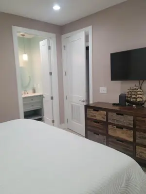 a bedroom with a bed and a desk and a television at Venture Out 600 Seabreeze Dr Comes WITH GOLF CART in Panama City Beach
