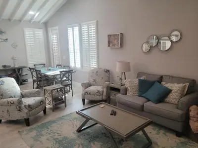 a living room with a couch and chairs and a table at Venture Out 600 Seabreeze Dr Comes WITH GOLF CART in Panama City Beach