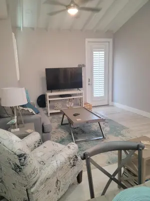 a living room with a couch and a tv at Venture Out 600 Seabreeze Dr Comes WITH GOLF CART in Panama City Beach
