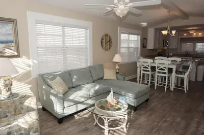 a living room with a couch and a table at Venture Out 476 Marlin Dr Comes WITH GOLF CART in Panama City Beach