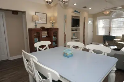 a living room with a white table and chairs at Venture Out 476 Marlin Dr Comes WITH GOLF CART in Panama City Beach
