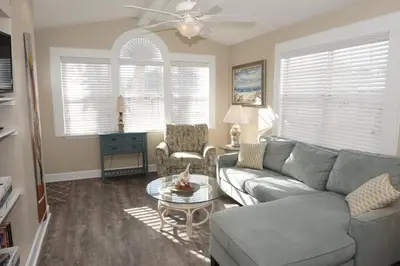 a living room with a couch and a table at Venture Out 476 Marlin Dr Comes WITH GOLF CART in Panama City Beach