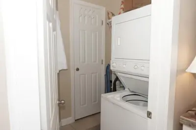 a white laundry room with a washer and dryer at Venture Out 476 Marlin Dr Comes WITH GOLF CART in Panama City Beach