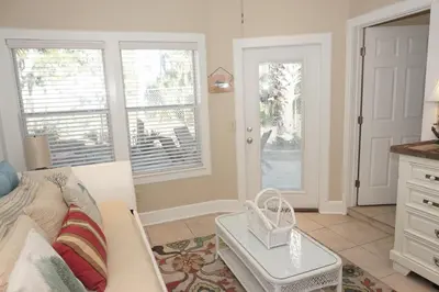 a living room with a couch and two windows at Venture Out 476 Marlin Dr Comes WITH GOLF CART in Panama City Beach