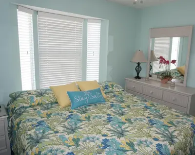 a bedroom with a bed with a pillow on it at Venture Out 402 North Marlin Dr WITH GOLF CART in Panama City Beach