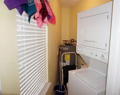 a laundry room with a washer and dryer next to a window at Venture Out 402 North Marlin Dr WITH GOLF CART in Panama City Beach