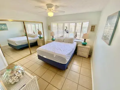 a bedroom with two beds and a mirror at Venture Out 332 Lagoon Ln WITH 2 GOLF CARTS in Panama City Beach