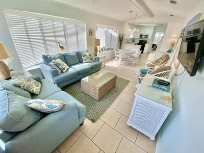 a living room with a blue couch and a table at Venture Out 332 Lagoon Ln WITH 2 GOLF CARTS in Panama City Beach